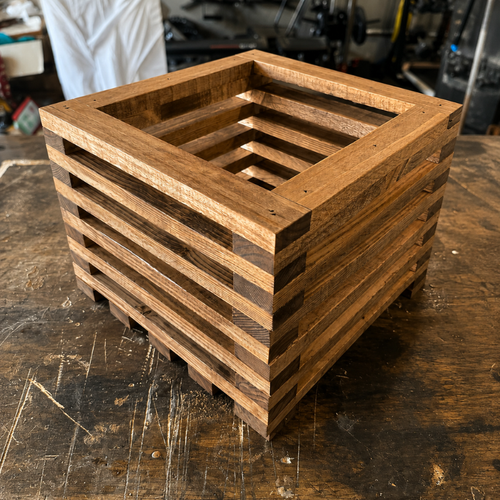 12×12 solid pine planter box with slatted wood construction, showcasing detailed joinery and sanded finish from angled views