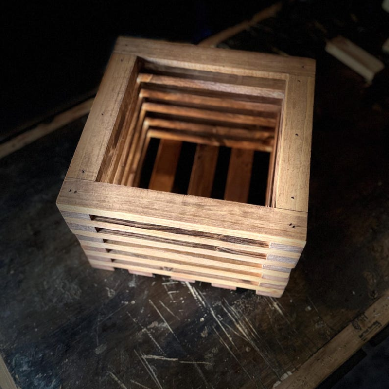 12×12 solid pine planter box with slatted wood construction, showcasing detailed joinery and sanded finish from angled views